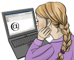 Das Bild zeigt eine Frau. Sie sitzt vor einem Laptop und schreibt eine E-Mail.